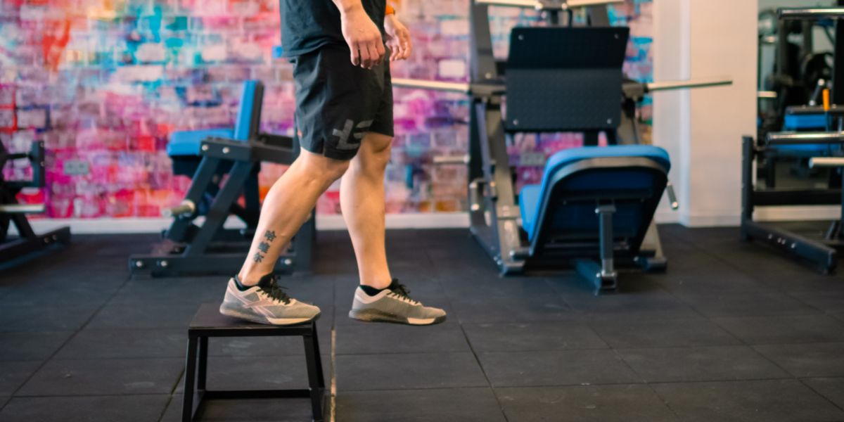 Step salendo e scendendo su un cassetto o su un'altra superficie rialzata. Esercizi senza pesi