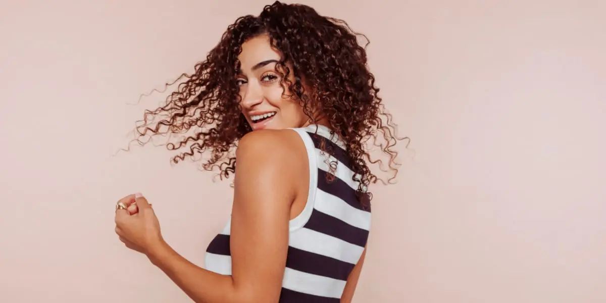 Donna con capelli ricci sorridente Donna con capelli ricci sorridente